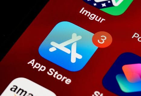 Close-up of App Store icon on iPhone screen with notification badge, highlighting app updates.